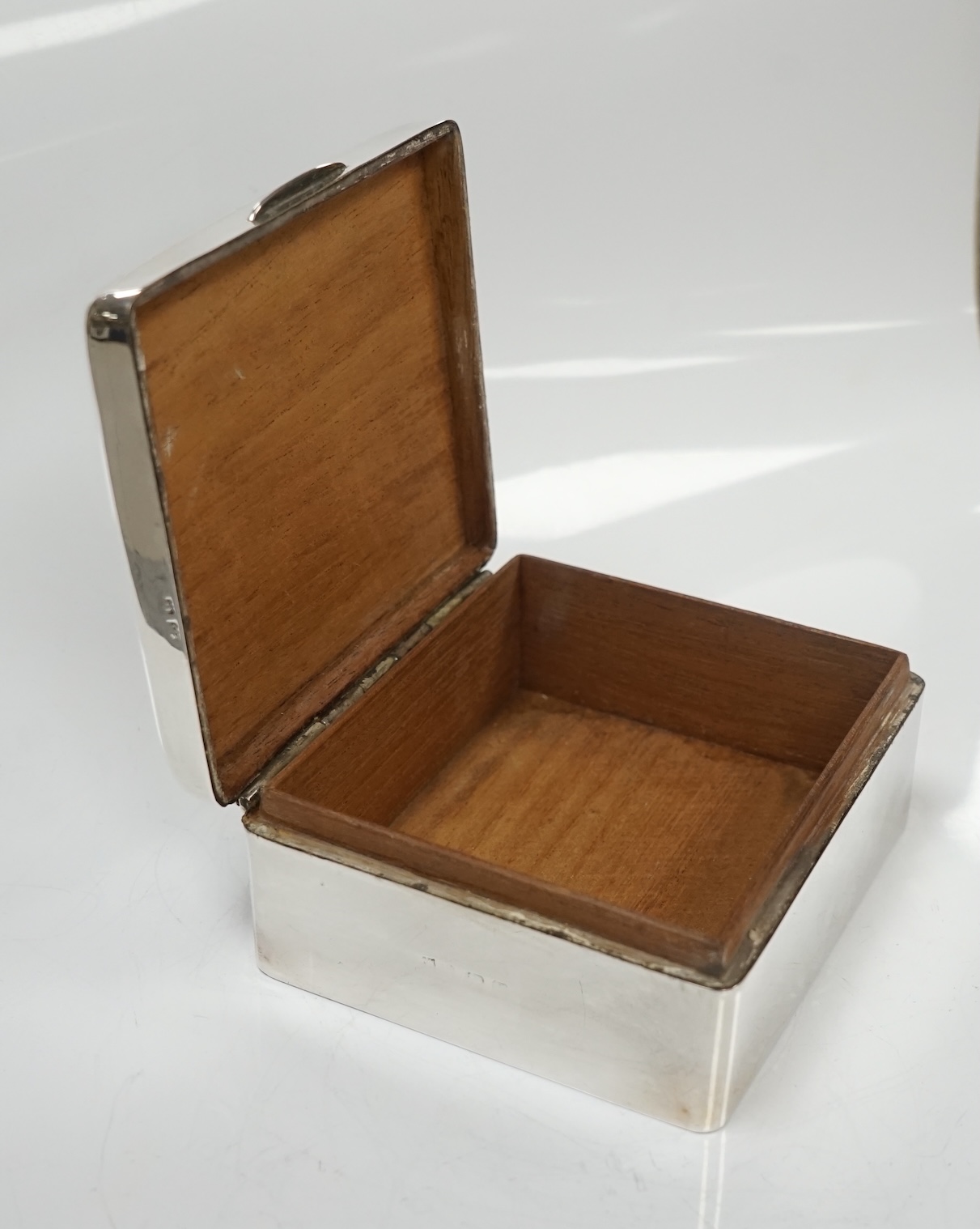 Two silver cigarette boxes, the largest by Stokes & Ireland, Chester, 1906, 14.7cm. Condition - poor to fair